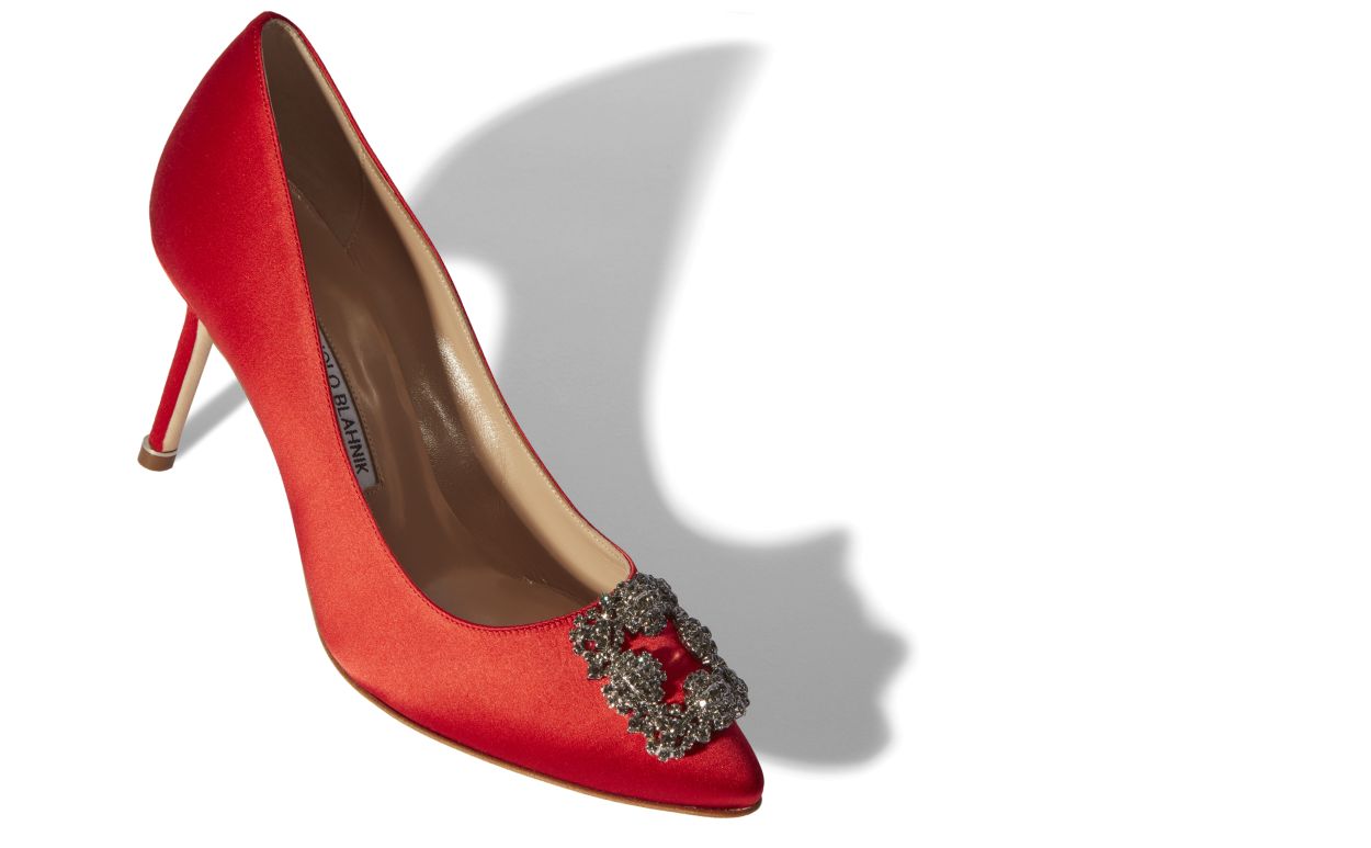 Ophelia Bloom Red Jewel Buckle Pumps – front three-quarter view showing red jewel buckle, crystal buckle, almond toe, satin…