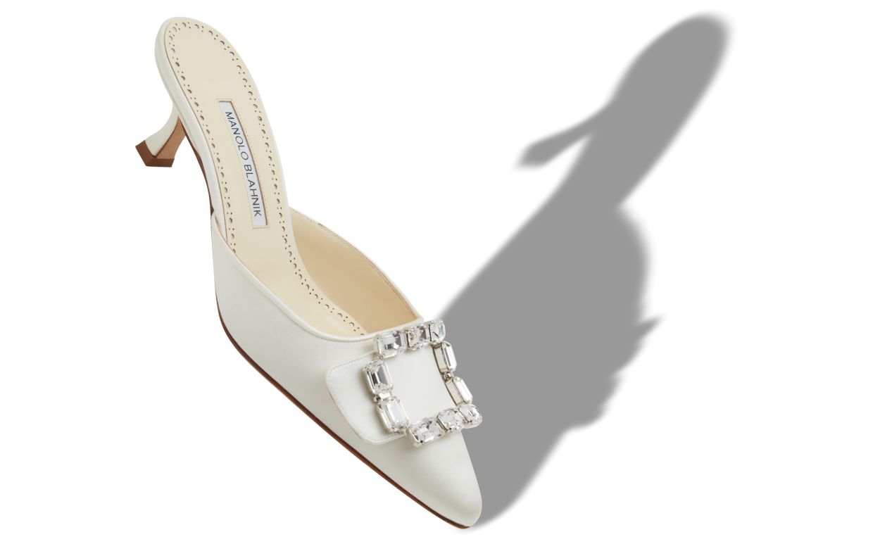 Isadora Lace White Crystal Buckle Mules – front three-quarter view showing white crystal buckle, pointed toe, satin…