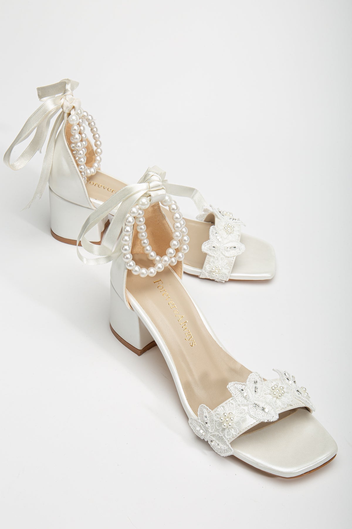 Amber - Ivory Lace Bridal Sandals with Pearls – front three-quarter view showing pearl, lace, ivory, SimmiUnique