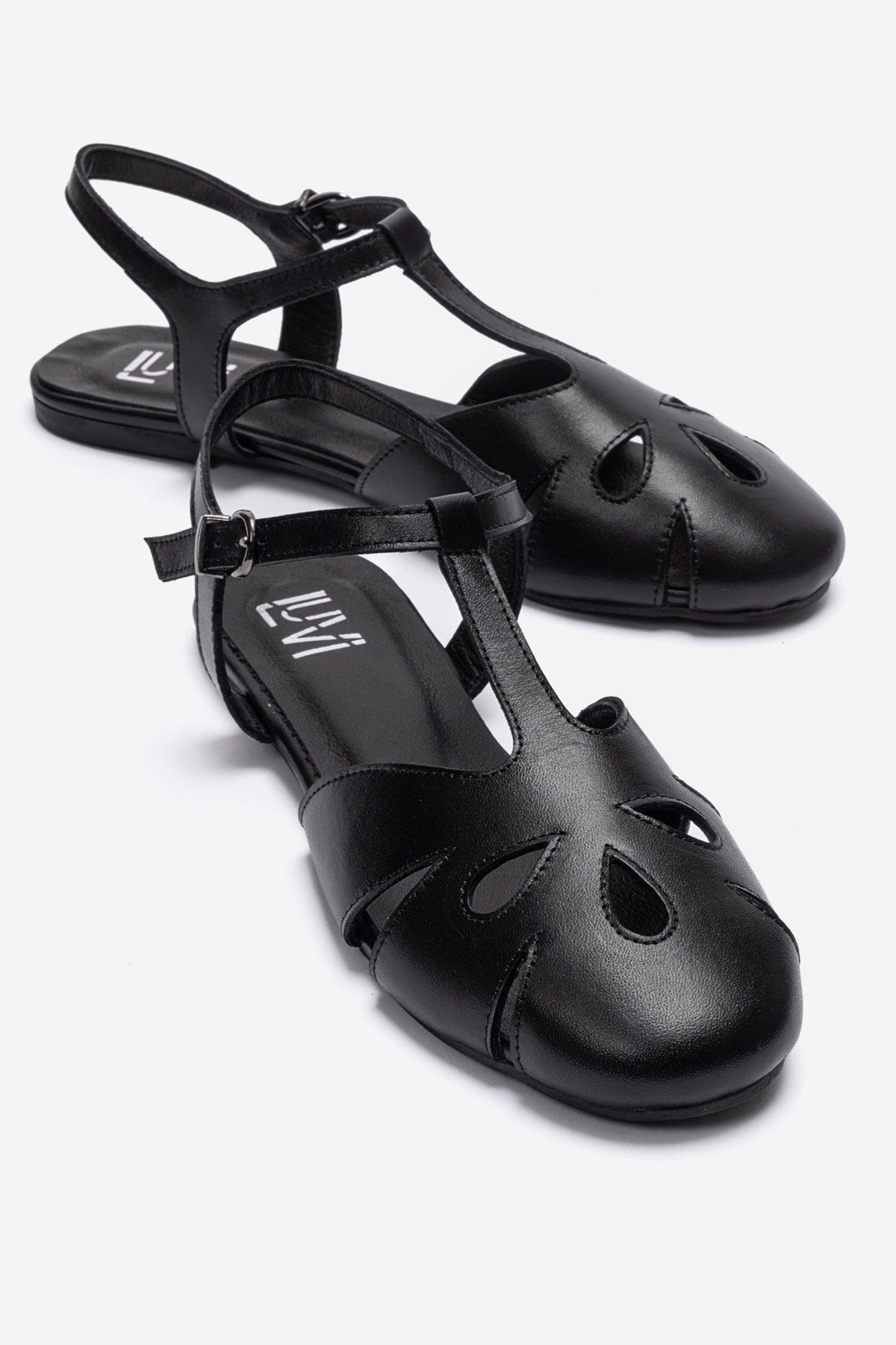 NATHALIE - Black Genuine Leather Ankle-Strap Flat Sandal – front three-quarter view showing leather, black, SimmiUnique