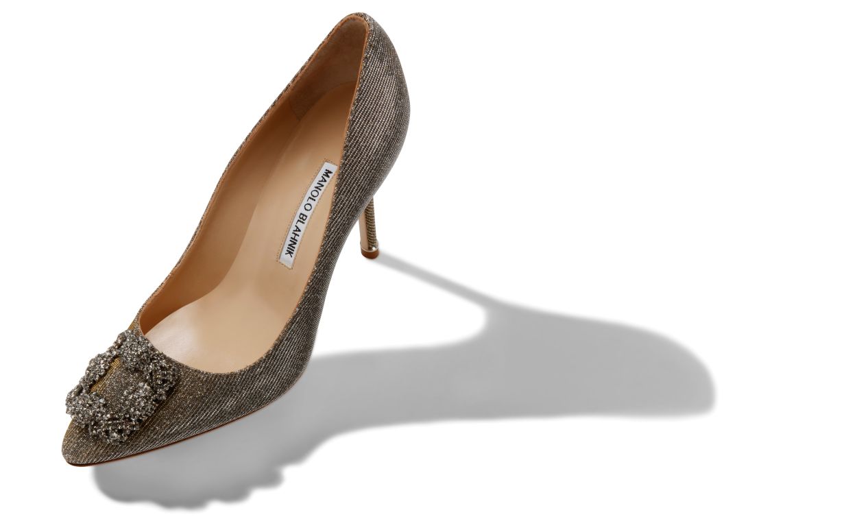 Valentina Crown Gold Jewel Buckle Pumps – front three-quarter view showing gold jewel buckle, crystal buckle, almond toe…